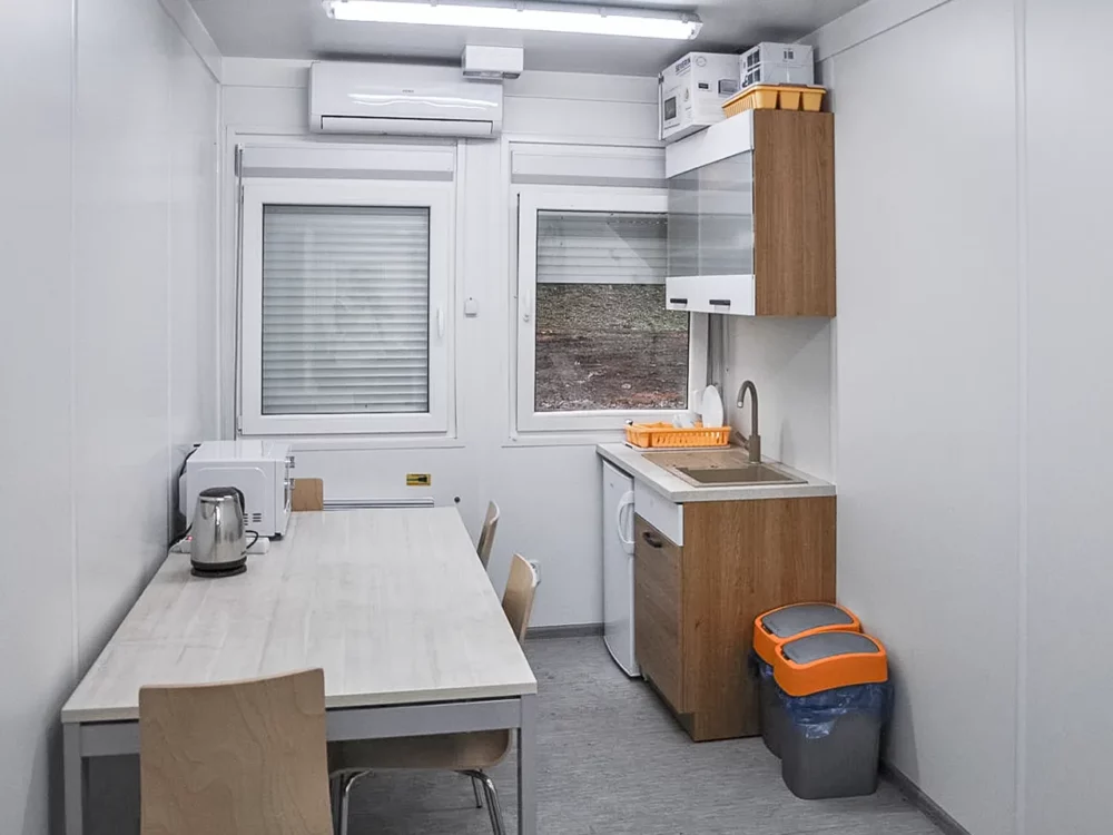 Innenansicht Mannschaftscontainer als Pausenraum mit Miniküche und Esstisch